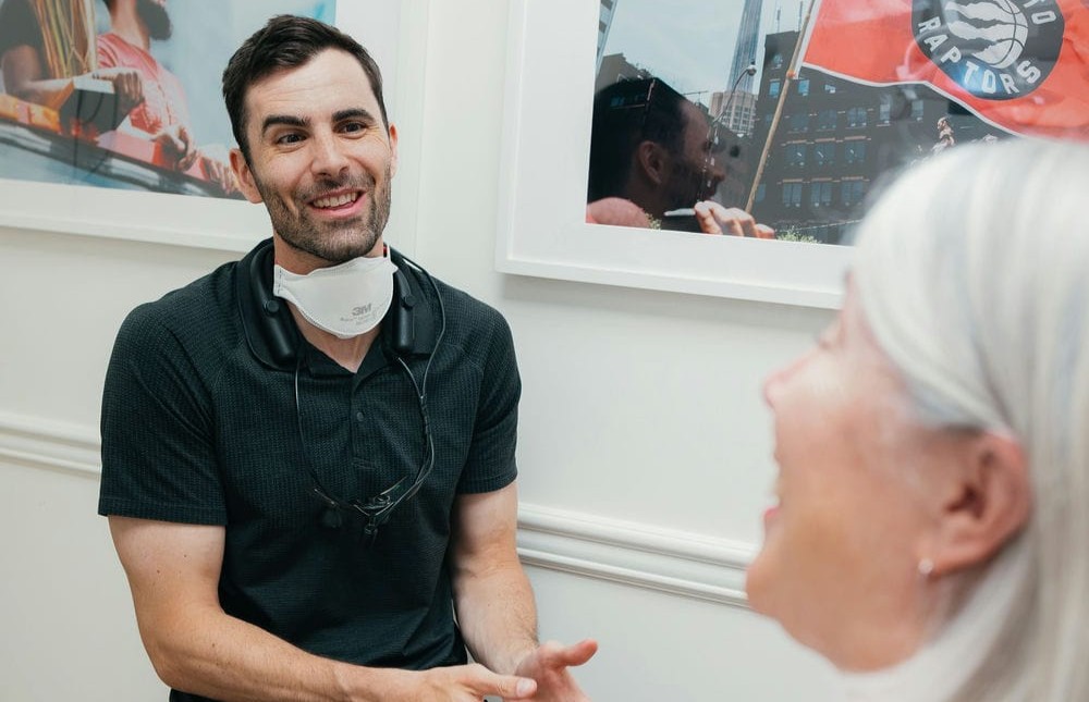 Dentist talking with a patient about whether a snoring mouth guard is a good fit for him