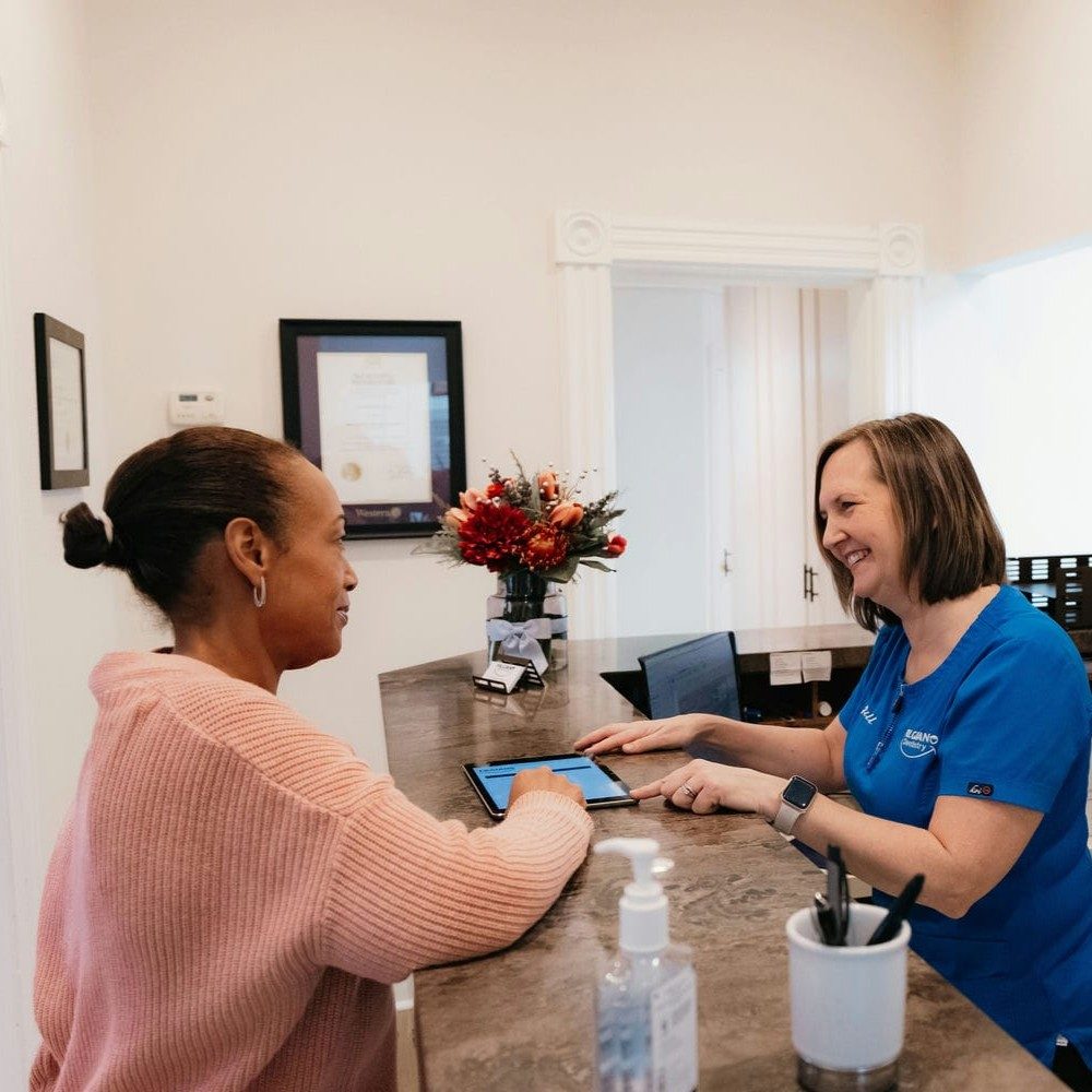 Patient booking her next dental cleaning appointment with the receptionist at a Markham dental office