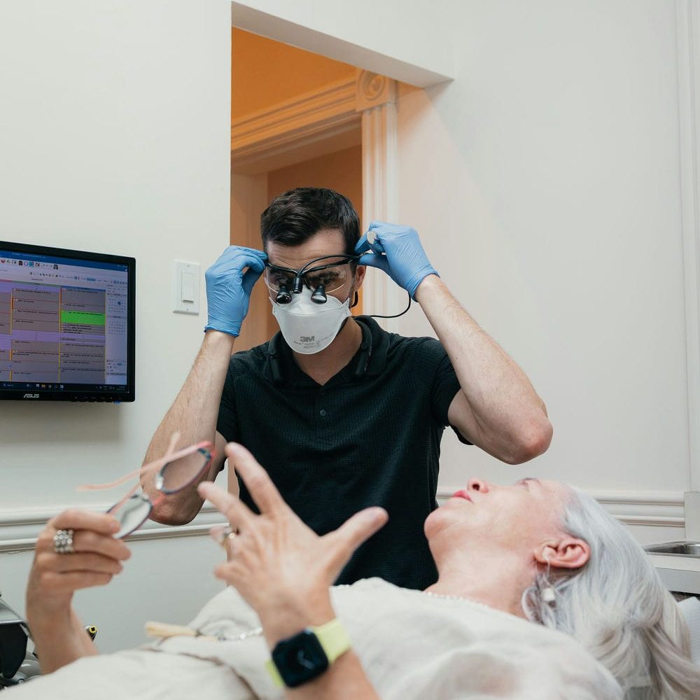 Markham dentist preparing beside a relaxed patient before a tooth extraction