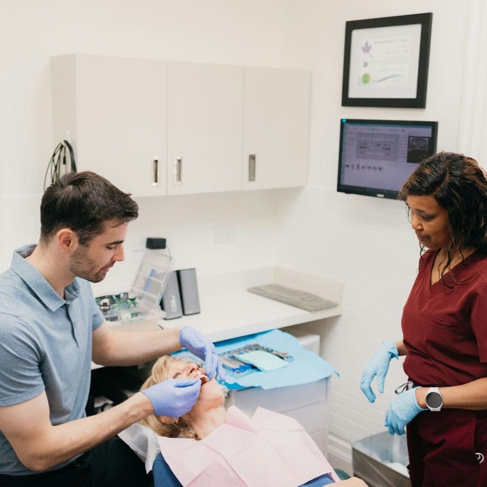 Dentist and assistant working together to keep a patient comfortable during a dental bridge appointment