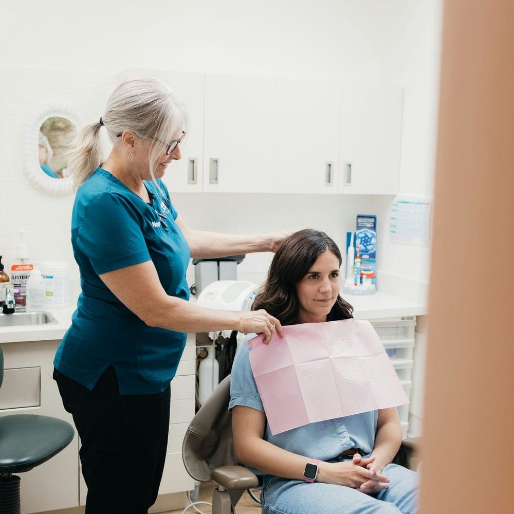 Dental assistant settling a patient in for a comfortable crown appointment at a Markham dental office