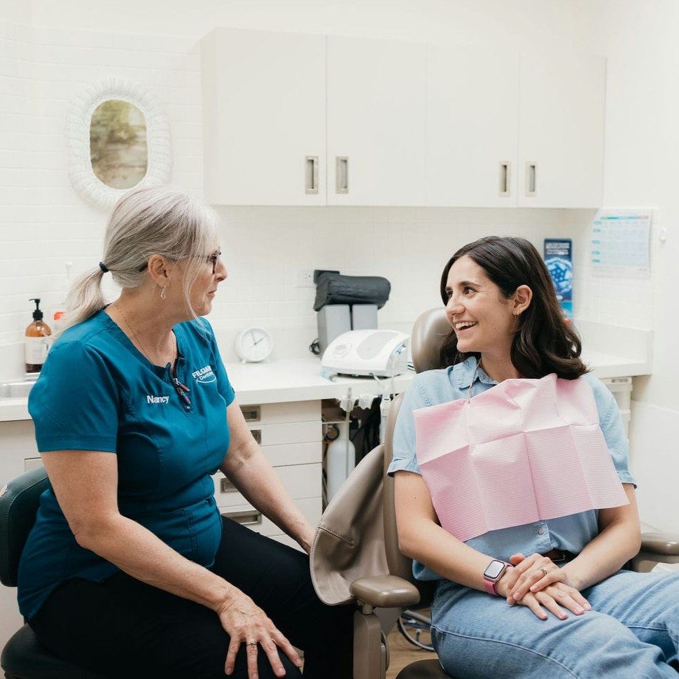 Patient smiling and at ease with her hygienist after cosmetic dental treatment in Markham