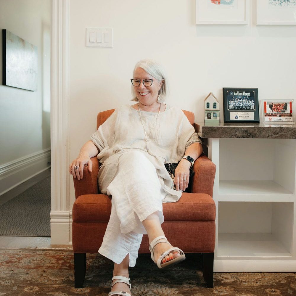 Patient sitting comfortably in a Markham dental waiting room before her cosmetic dentistry consultation