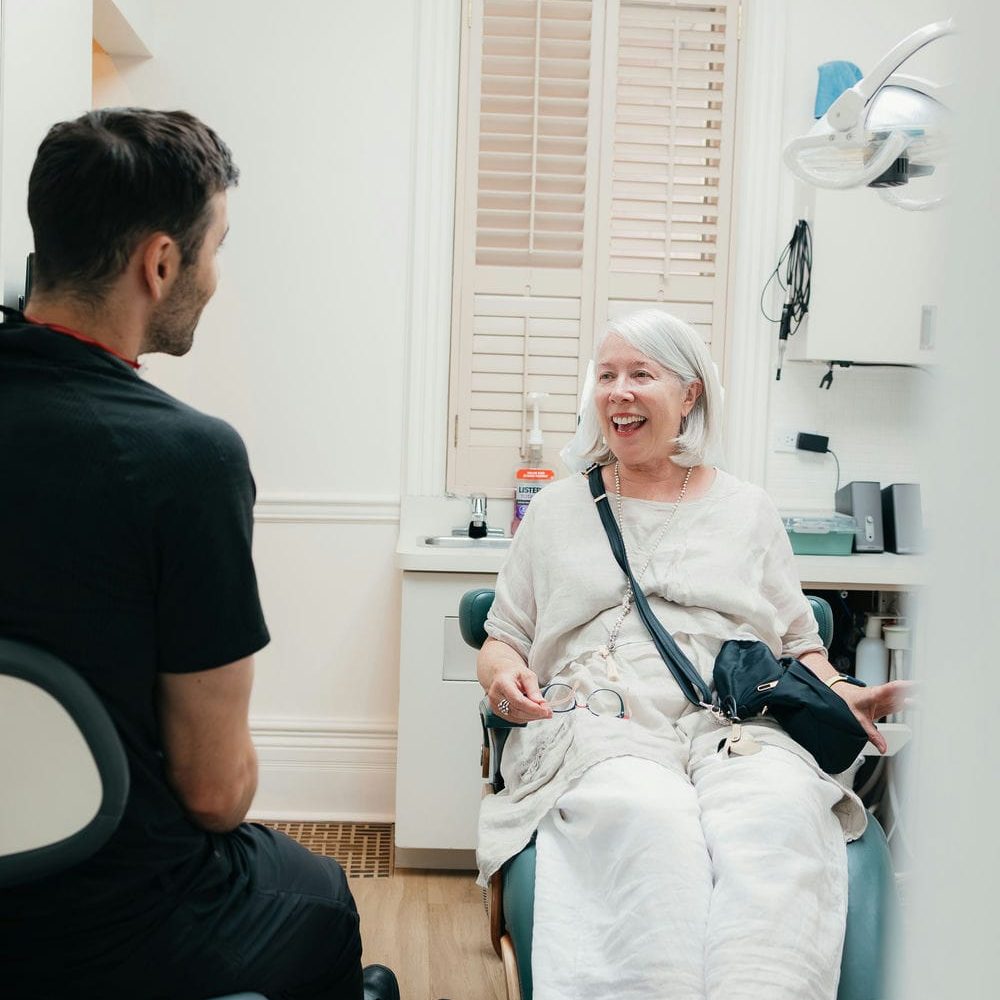 Markham dentist talking calmly with a patient in the chair during a dental bonding consultation