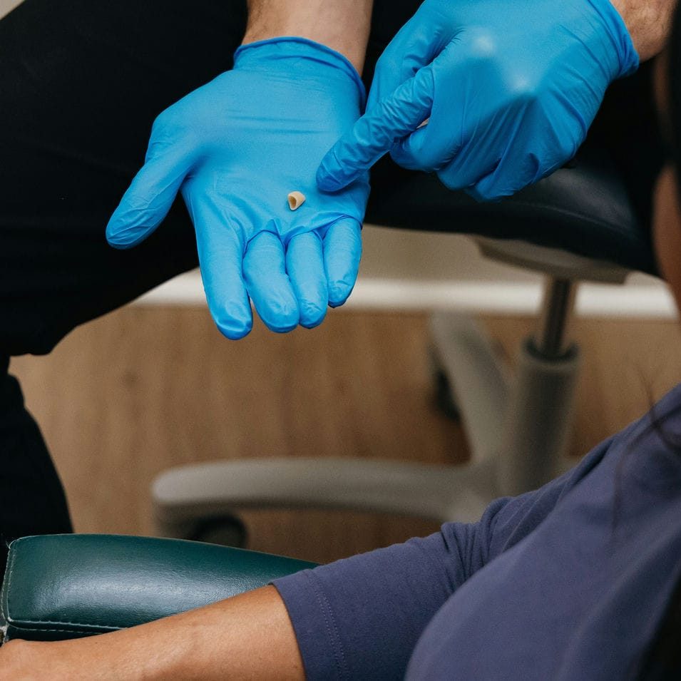 Dentist holding a porcelain crown, the restoration recommended when bonding is not the best choice