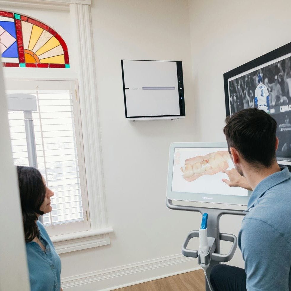 Markham dentist and patient reviewing a 3D scan of her teeth while planning a dental crown
