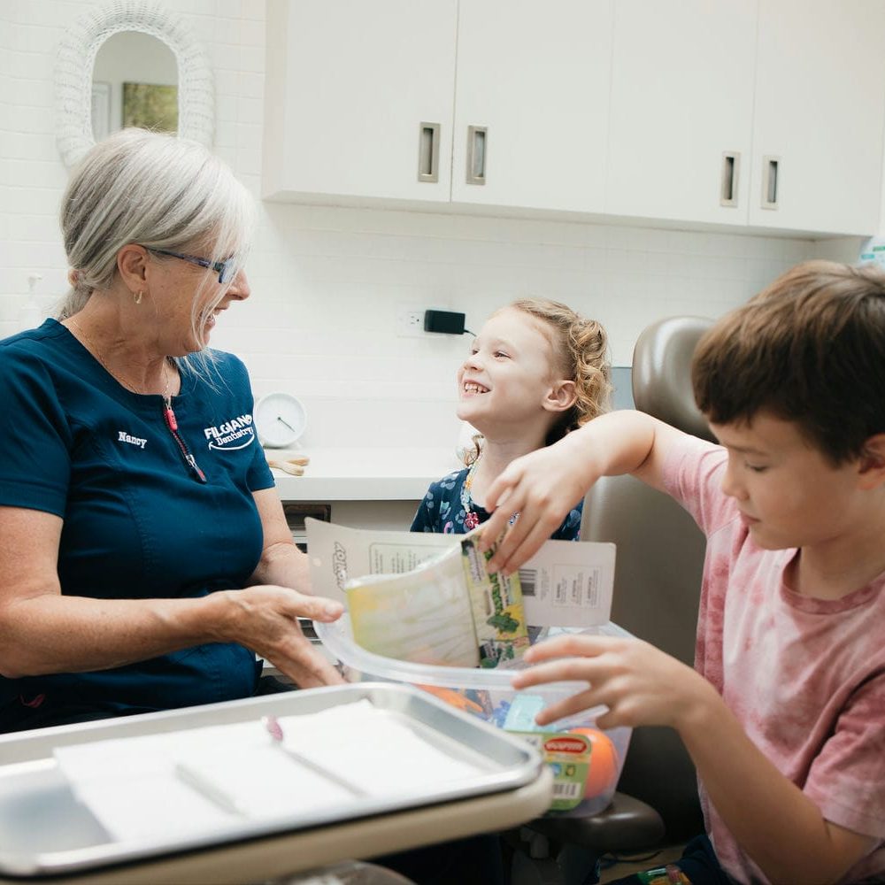 Children choosing a prize from the treasure bin after their dental appointment in Markham