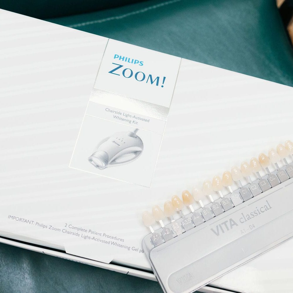 Professional whitening kit and tooth shade guide used to keep cosmetic results looking natural over time