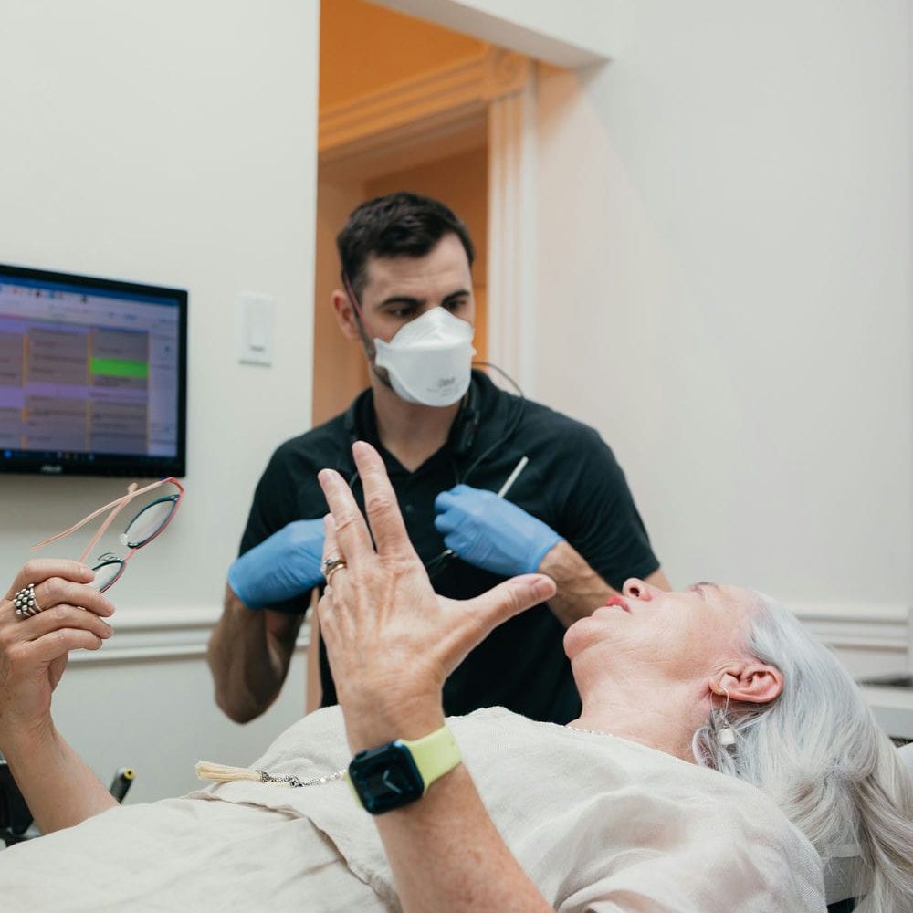 Patient talking through her treatment options with the dentist from the chair