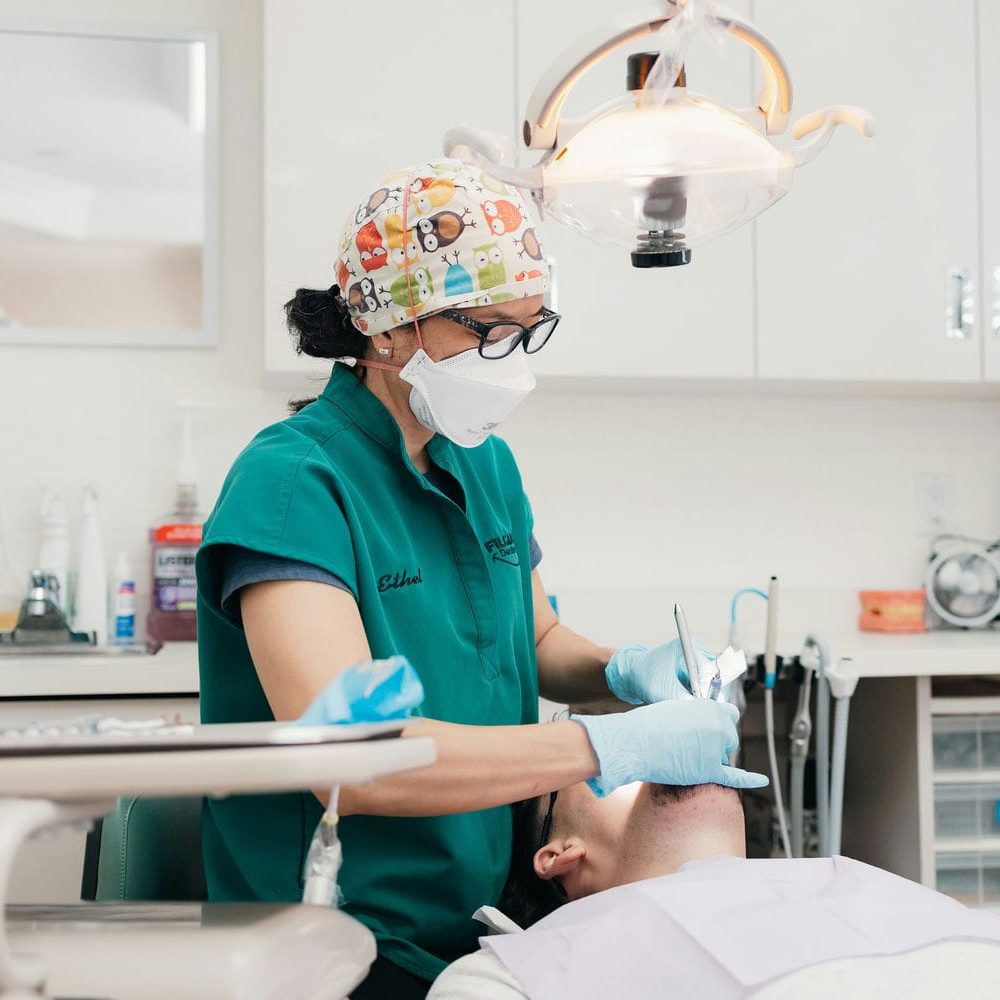 Dental hygienist removing plaque and tartar from a patient's teeth during a professional cleaning in Markham