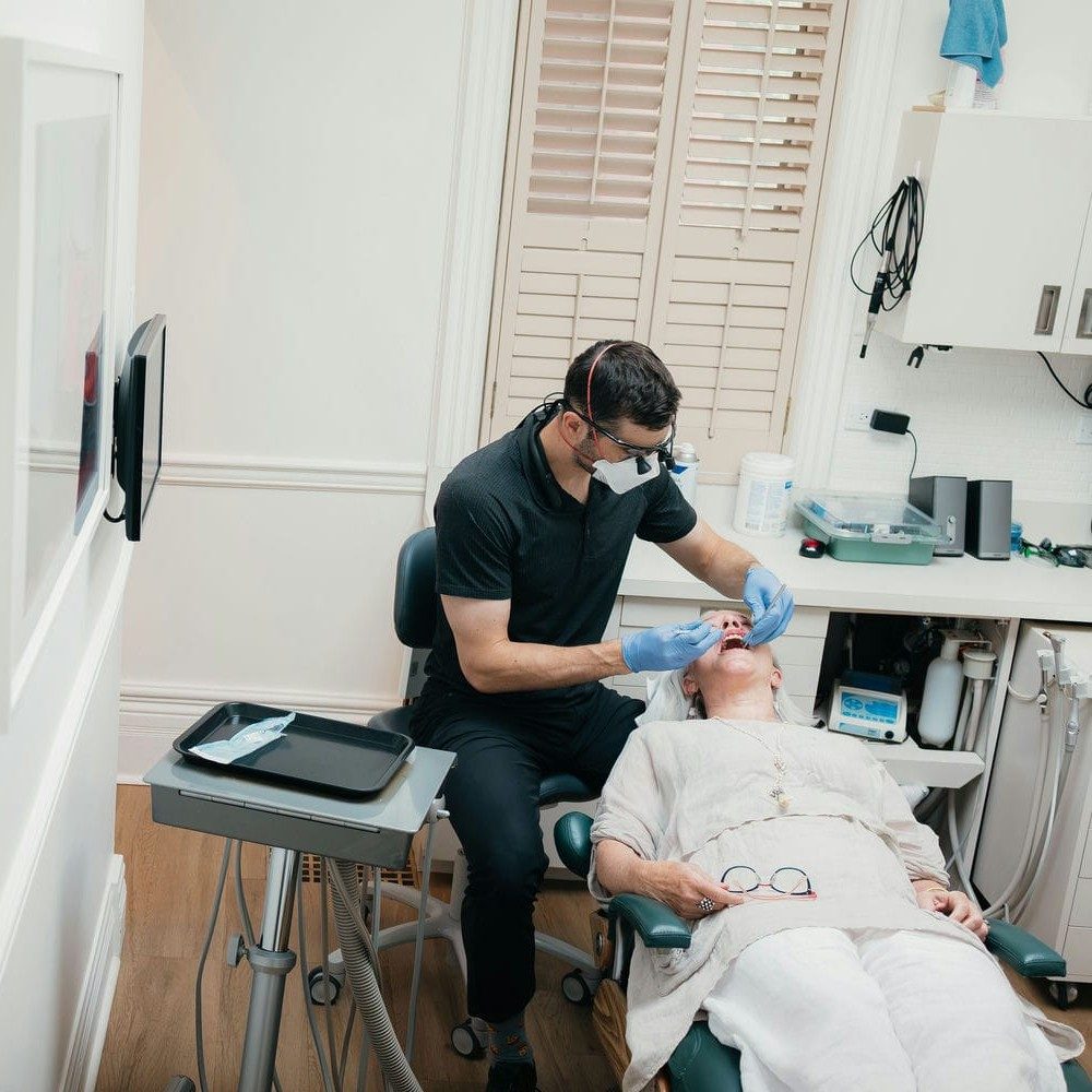 Dentist treating a patient during a regularly scheduled cleaning visit in a Markham treatment room